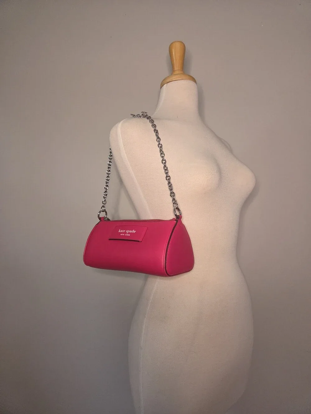 Kate Spade New York label convertible pochette in rosehip pink leather.